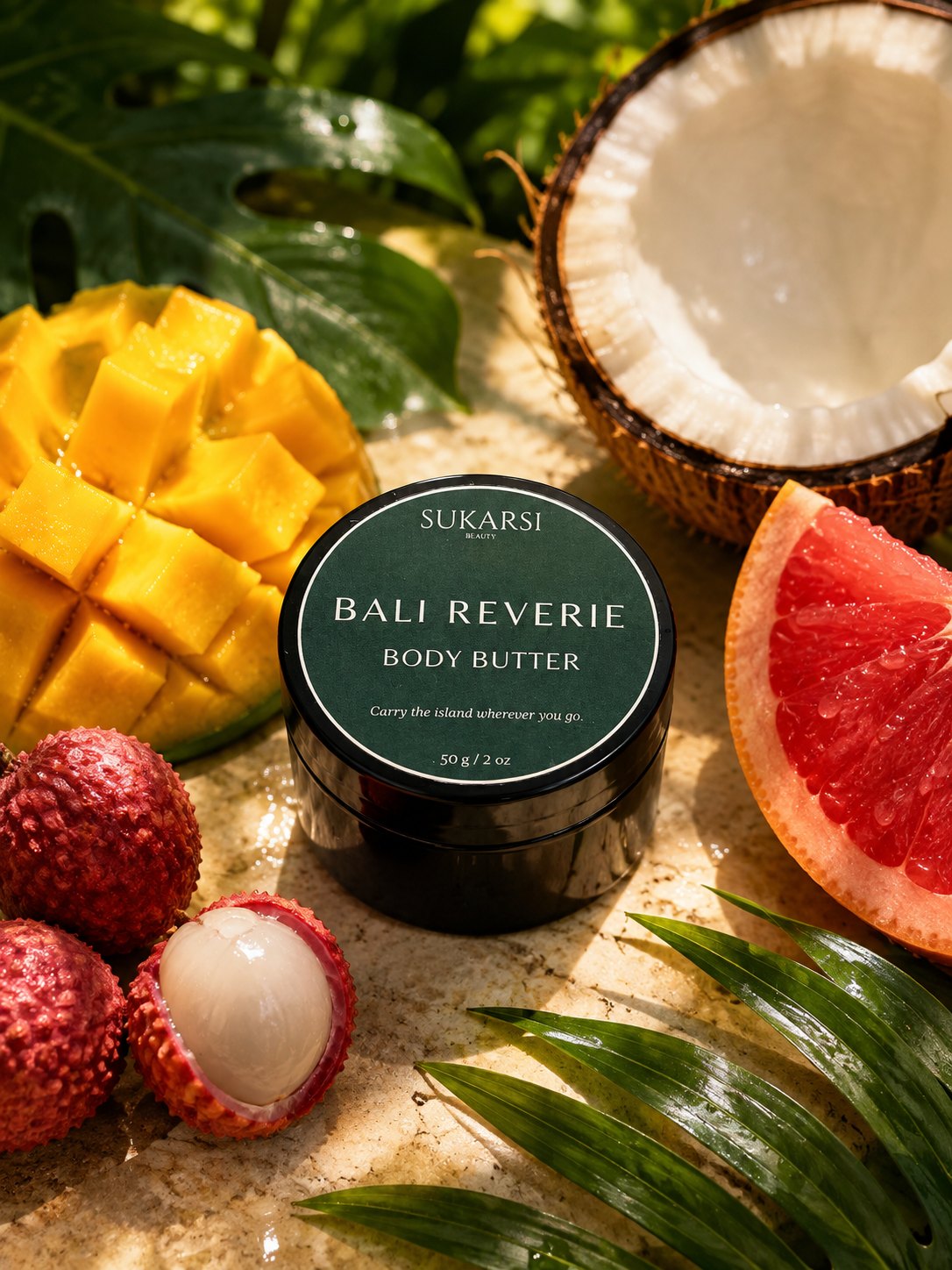 Bali Reverie body butter surrounded by tropical fruit in bright sunlight